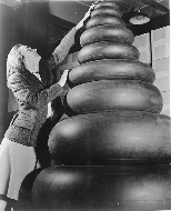 Woman_standing_next_to_small